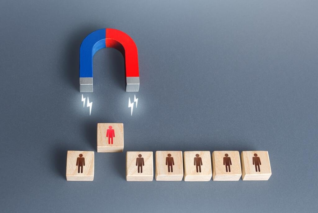 The magnet selects one person from the row. Finding the best recruiting candidate